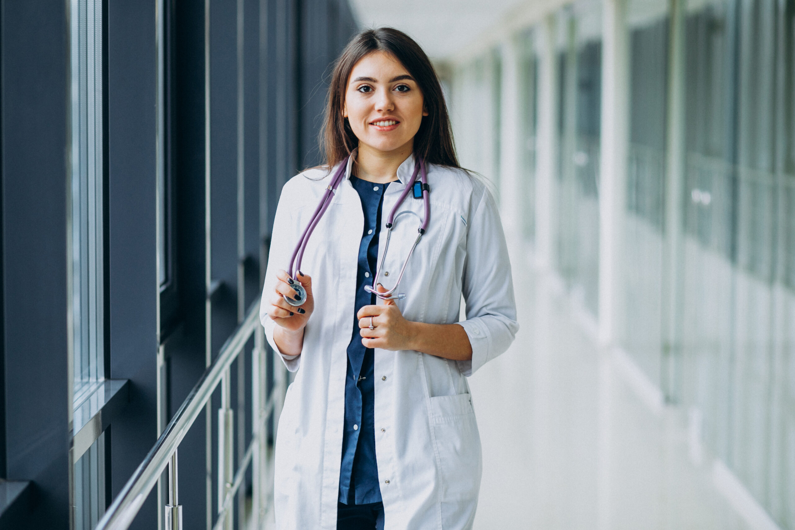 Young woman doctor with stethoscope at hospital